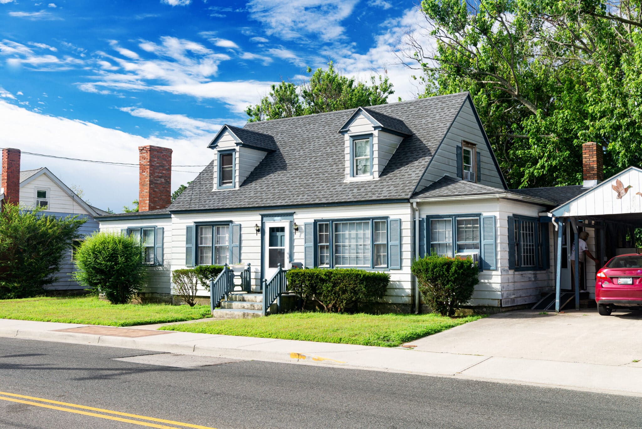 small nice house with a well-groomed lawn.